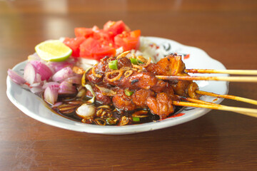Indonesia chicken satay with black soya sauce one of famous local dishes closeup view