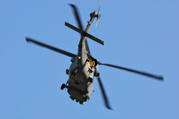 A military helicopter that passes over the sky.