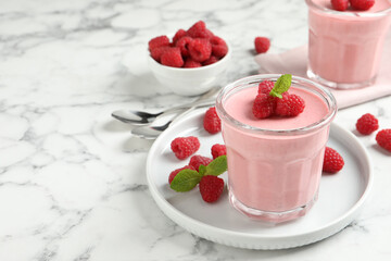 Delicious raspberry mousse with mint on white marble table, space for text
