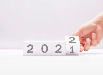 arranging white block with 2021 to 2022, happy new year anniversary of world