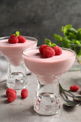 Delicious raspberry mousse with mint on light grey table