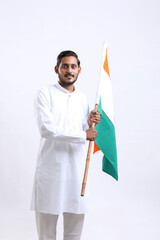 Young indian man holding indian national flag in hand over white background