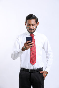 Young indian businessman or employee using smartphone.