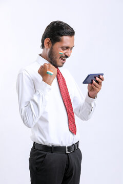 Young indian businessman or employee using smartphone.