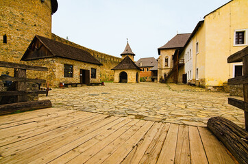 Picturesque landscape view of courtyard with ancient stone buildings in the old medieval castle....