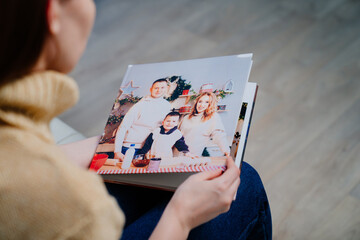 woman watches photobook from a family photo shoot