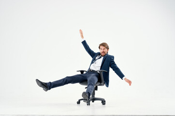 business man in a suit rides in a chair emotions work manager