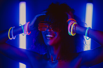 Cyberpunk style portrait of glamorous african woman on party under glowing colorful light....