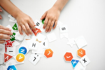 English alphabet, children's hands on the table