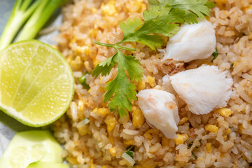 Crab meat fried rice on ceramic dish set on table.