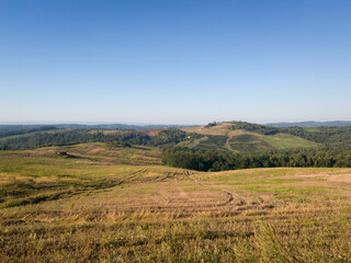 Obraz premium Scenic view of hilly countryside in village of Bukovica near Derventa during clear sunny summer day.