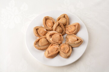 raw 10 head fresh abalone in slice and whole piece in white background asian seafood halal sashimi menu