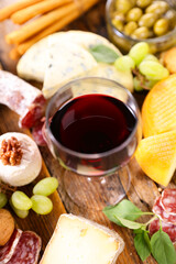 red wine glass with various cheese
