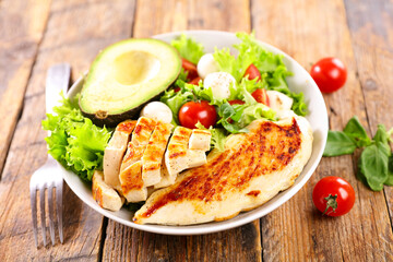 Fototapeta na wymiar grilled chicken fillet with salad and avocado