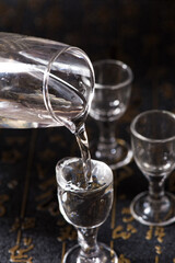 liquor or liquor is poured into a glass from a bottle background
