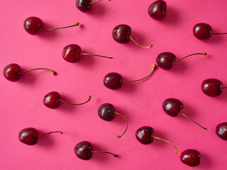 Ripe cherries berries on a pink background