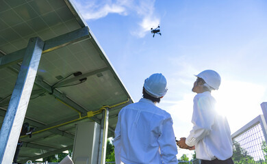 Engineer inspect and checking solar panel by Drone at solar power plant.