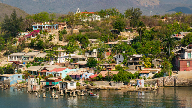 Cuban poor colorful village with church on the hill near city Santiago de Cuba  
