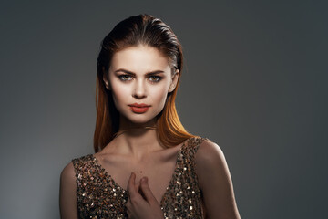 woman in gold dress and earrings jewelry Glamor model