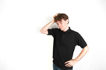 Portrait of a worried guy with his hand in the head looking down, white background, 18-20 years old. White european guy.