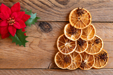 Christmas flat lay composition. Christmas handmade Tree made of dried oranges and anise on wooden background. Winter holidays, new year concept. Still life. Top view, copy space for text