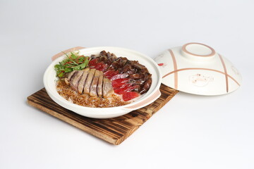 cook assorted chinese waxed meat with rice and dark soy sauce in hot clay pot asian menu