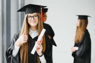 Educational theme: graduating student girl in an academic gown.