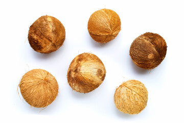 Top view of ripe coconuts on white