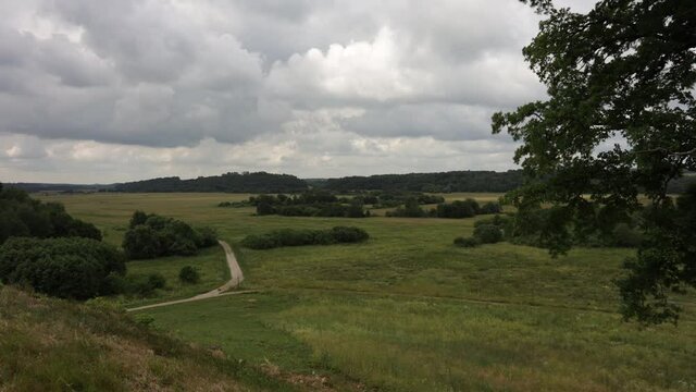 Fast moving clouds over rural landscape in Lithuania. View from Imbare mound historical place. Time lapse video. 