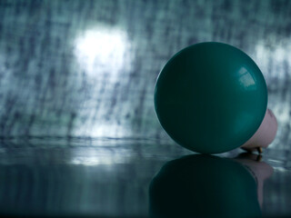 turquoise blue color electric bulb zero watt side view with reflection light blur background.