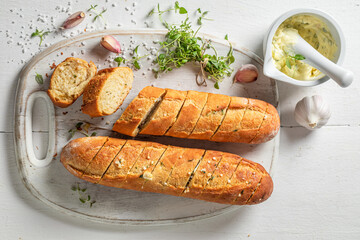 Delicious garlic bread with herbs. Baguette with garlic.