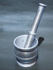 Silver metal food spice hand crusher isolate at black background, kitchen cutlery product image.