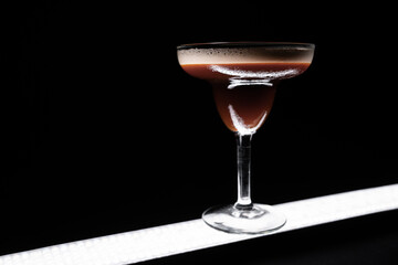 luxury espresso martini cocktail drink in elegant glass on black background