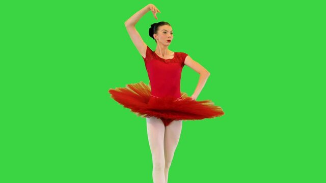 Young ballerina in classical tutu makes some ballet movements on a Green Screen, Chroma Key.