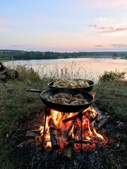 cooking on the fire in nature sunset