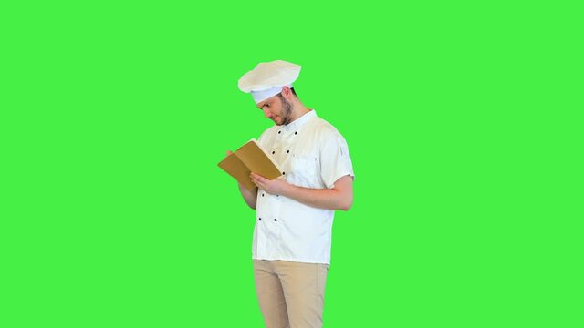 Professional chef cook walk make notes in notebook create new recipe of gourmet dish for restaurant on a Green Screen, Chroma Key.