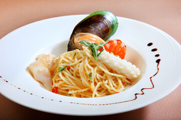 cook pasta noodle with carbonara aglio olio sauce and seafood, bacon, mushroom muscle octopus...