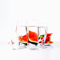 Distorted view of watermelon through the lenses of jars with water
