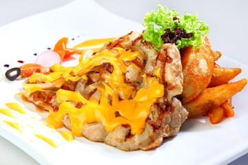 bbq grill bake meat platter with chicken cutlet, beef steak, pork chop in cheesy cream sauce French fries and salad western menu