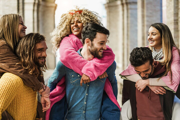 Young multiracial people having fun outdoor in the city - Focus on center man face