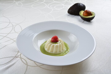 luxury chilled sweet coconut pudding jelly with avocado creamy sauce and raspberry fruit in plate and pink table cloth halal dessert menu