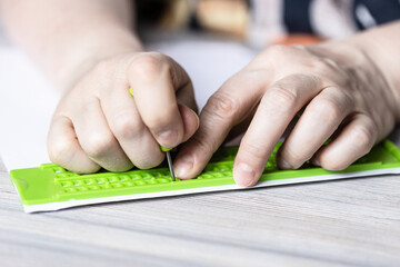 front view of printing in braille with slate