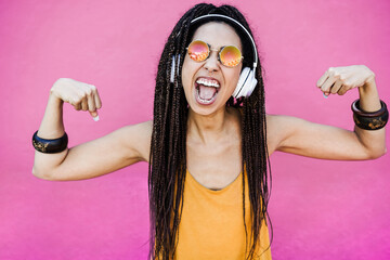 Bohemian african girl listen playlist music with headphones - Focus on face