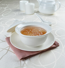 luxury chilled sweet fresh bird nest soup with almond paste and peach resin in bowl and pink table cloth halal healthy dessert menu