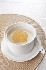 luxury chilled sweet fresh bird nest soup with almond paste and peach resin in bowl and pink table cloth halal healthy dessert menu