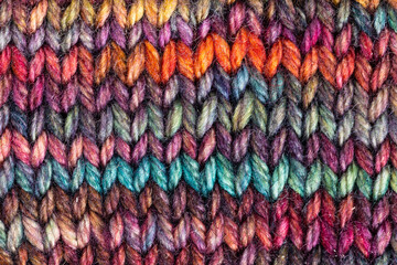 Fototapeta na wymiar pied hand-knitted woolen fabric close up