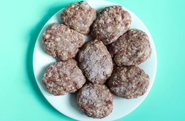 Homemade minced meat cutlets on a white plate. Home cooking meat cutlets close up