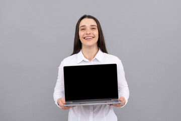 happy woman in white shirt showing computer ad presentation, copy space, modern life