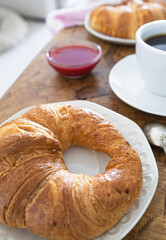 Breakfast with croissants, coffee and fresh fruit. Weekend breakfast. Breakfast and reading on Saturday morning. Lifestyle photography