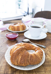 Breakfast with croissants, coffee and fresh fruit. Weekend breakfast. Breakfast and reading on Saturday morning. Lifestyle photography